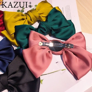 Detail of high-density silk satin bow hair clips with premium metal spring fasteners