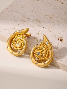 Detail of spiral titanium steel earrings with crystals and 18k gold plating finish