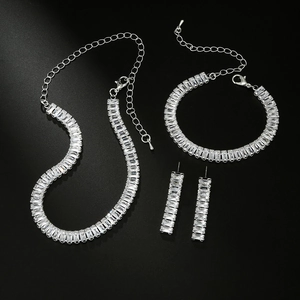 Elegant silver zircon jewelry set with necklace bracelet and earrings on black background