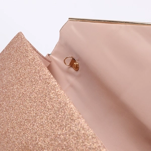 Detailed macro view of the sparkling rose gold glitter evening bag with a gold D-ring buckle