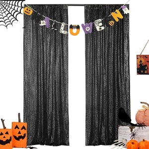 Close-up of black sequin tablecloth used as Halloween backdrop with pumpkin decorations