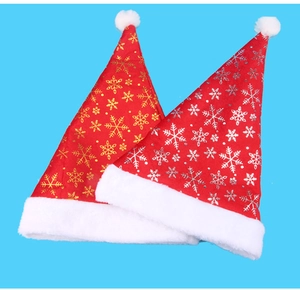 Detailed view of red plush Christmas hats with gold and silver snowflake prints