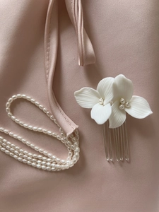 Detail of white ceramic flowers and freshwater pearls on silver 5-tooth bridal hair comb