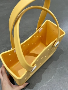 Top view of bright yellow EVA beach tote with round drainage holes and matching handles