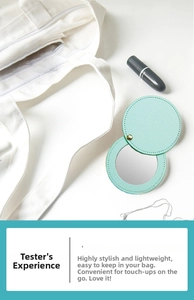 Close-up of a mint green PU leather mini makeup mirror in a stylish lifestyle setting