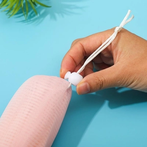 Detail showing the white drawstring and spring buckle on a 6-layer pink foaming mesh bag