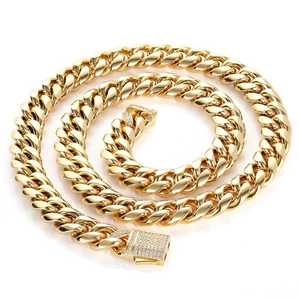 Golden stainless steel Cuban chain necklace with iced out crystal buckle on white background