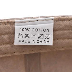 Detailed close-up of 100% cotton material and care label inside the washed baseball cap
