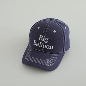 Detail of dark blue cotton baseball cap with Big Balloon embroidery and white stitching