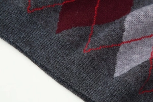 Macro detail of Argyle knit sweater with diamond pattern and soft fiber texture