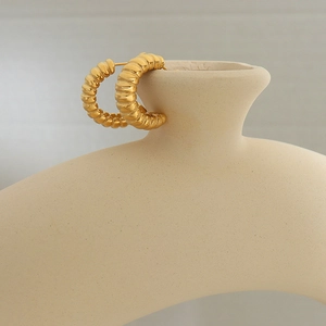 Golden titanium steel C-shaped twisted earrings with a modern textured ribbed design