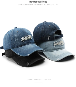 Macro shot of embroidered letters and distressed details on denim baseball caps in four colors