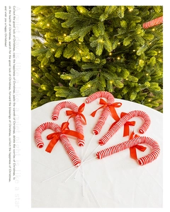 Detail of five red and white striped fabric candy canes with bows for Christmas tree decor