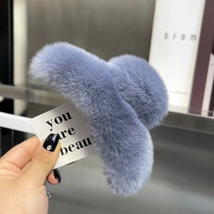 Detail of greyish blue rex rabbit fur hair claw clip showing soft plush texture and label