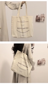 Detail showing hand-held and shoulder-carry styles of the beige canvas tote bag