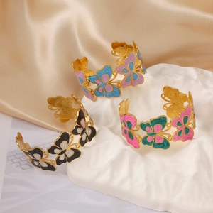 Elegant butterfly enamel open bracelets in three colors on luxury champagne silk fabric