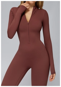 Detail of deep brick red thermal yoga bodysuit with front zipper and sleek elastic fabric