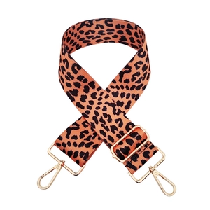 Close-up of leopard print shoulder strap with adjustable golden lobster claw hardware