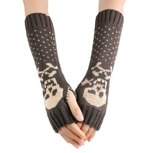 Close-up of dark brown knitted fingerless gloves with beige skull and polka dot patterns