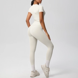 Detail of high-waist yoga leggings and short sleeve top showing slim fit and lift effect
