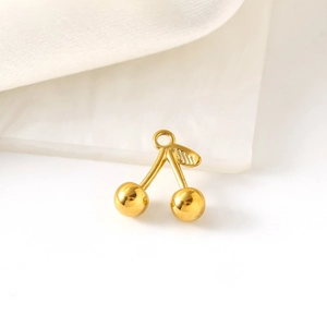 3D cherry shaped 18K gold plated stainless steel pendant on white marble backdrop