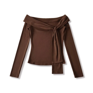 Close-up of chocolate brown off-shoulder top with decorative ribbon knot detail