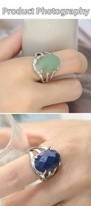 Detailed close-up of oval green agate and blue lapis rings with silver镂空 bands