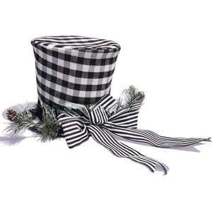 Close-up of black and white plaid Christmas tree topper with pine cones and bow decoration