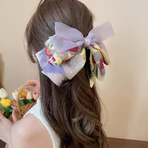 Elegant purple organza floral bow hair claw clip for women shown on a model's ponytail