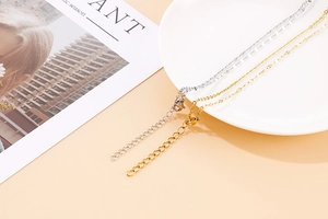 Detailed view of gold and silver stainless steel chain necklaces with lobster clasps