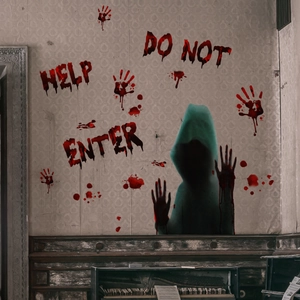 Close-up of Halloween bloody handprints and HELP text stickers on a spooky window