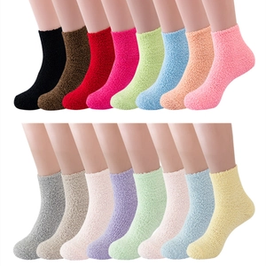 Collection of 16 colorful plush coral fleece slipper socks displayed on foot models