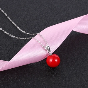 Elegant S925 sterling silver necklace featuring a vibrant red pearl pendant on silk