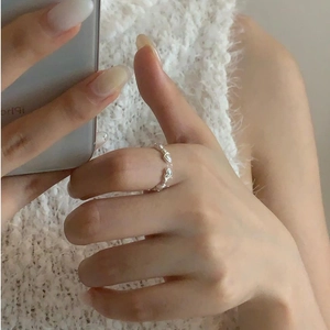 Detailed view of an S925 sterling silver ring with multiple small heart motifs on hand