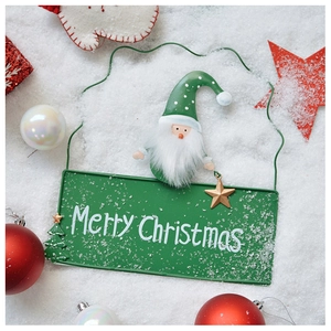 Christmas iron hanging sign with Merry Christmas text on a snowy background
