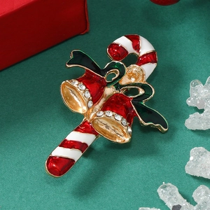 Detail of Christmas candy cane brooch with red enamel bells and green bow tie accent
