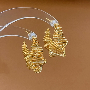 Detailed view of golden spiral geometric earrings with twisted wire metal design