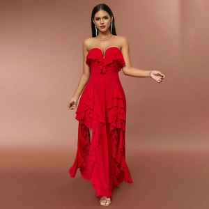 Detail of red strapless evening dress featuring layered ruffles and high-low chiffon hemline