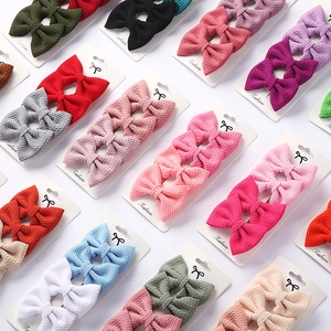Detail of colorful fabric bow hair clips set for babies on white background