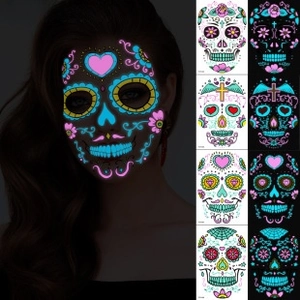 Glow in the dark Day of the Dead face stickers featuring neon skull and spider designs