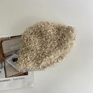 Detailed texture of the beige curly plush bucket hat with soft lamb wool finish