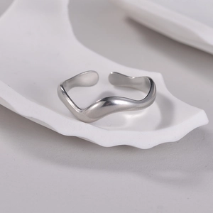 Minimalist silver wavy open ring in stainless steel with a sleek polished finish
