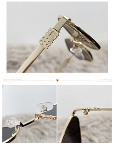 Detail of golden metal sunglasses with branding, soft nose pads and precision hinges