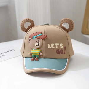 Detail of baby baseball cap with 3D ears and cartoon bear patch on a khaki crown