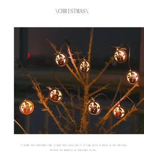 Detail of warm white snowman LED string lights hanging on a Christmas tree branch