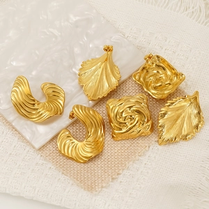 Three pairs of vintage gold titanium steel earrings featuring leaf and wavy patterns