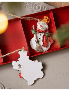 Detail of vintage snowman resin ornament set with red plaid scarf and hemp hanging rope