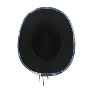 Detail shot of blue denim jazz hat featuring black lining and brown leather tassel charm