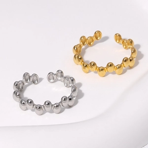 Detailed view of 18K gold and silver plated irregular geometric beaded open rings