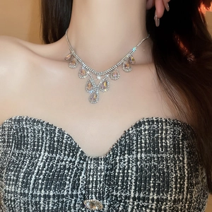 Detail of luxury teardrop crystal necklace set on a model for an elegant bridal look